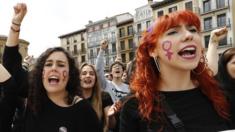 Protesters raise their arms in Pamplona on April 28, 2018, in the third day of demonstrations after five men were cleared of rape