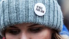 A woman has a pin on her to pay tribute to murdered Slovak journalist Jan Kuciak on March 2, 2018 in Bratislava, Slovakia.