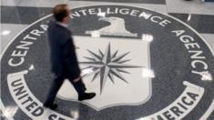 man walking over CIA logo on floor