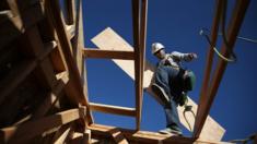 A worker carries lumber as he builds a new home on January 21, 2015 in Petaluma, California. According to a Commerce Department report, construction of new homes increased 4.4 percent in December, pushing building of new homes to the highest level in nine years