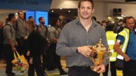 All Blacks captain Richie McCaw arrives back home with the Rugby World Cup trophy at Auckland Airport
