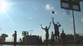 Youths playing basketball at youth centre in Philadelphia