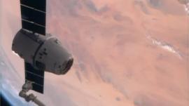 Watch footage of the ISS robotic arm grabbing onto the goodies.