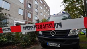 A barrier tape and a police vehicle of the criminal technology block the access to an house in the district of Paunsdorf in Leipzig, eastern Germany on October 10, 2016