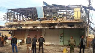 Iraqis gather outside a cafe in Muqdadiya that was attacked in a double bombing (12 January 2016)