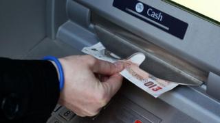 Money being taken out of an ATM