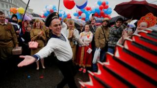 A man wearing a navy uniform performs before a May Day rally in central Moscow, Russia May 1, 2018.