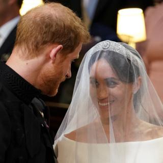 Prince Harry, Duke of Sussex (L) and US actress Meghan Markle (R) stand together at the altar in St George's Chapel, Windsor Castle, in Windsor,