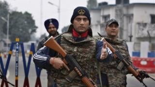 Indian soldiers stand guard at the airbase in Pathankot, India, Monday, Jan. 4, 2016.