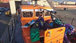 Kites and boards were brought ashore by the RNLI's Rhyl all-weather lifeboat