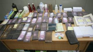 The evidence seized by police is arranged on a table at a press event held by the authorities