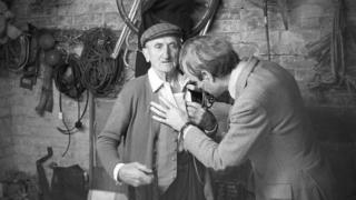 Dr Richard Westcott listening to his patient Bill Brown's chest