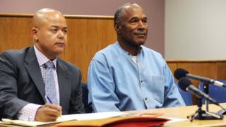 OJ seated beside his lawyer