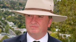 Barnaby Joyce, wearing a broad-brimmed hat, announces his decision on Friday