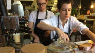 Two people working in bakery