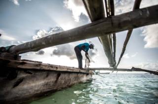 Abdullah Ali prepares to launch his traditional wooden boat
