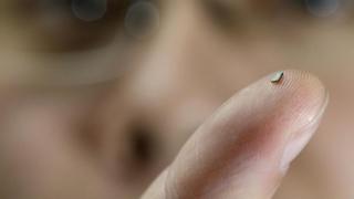 PhD student Hao Gao holds the tiny sensor on his finger