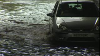A car driving through floodwater