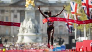 Vivian Cheruiyot of Kenya celebrates after crossing the finish line
