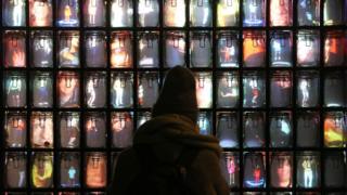 A person looks at Supercube by Stephane Masson on display in St James's Market