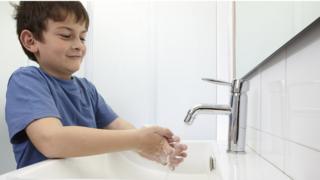 Boy washing hands
