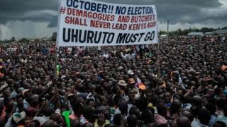 Supporters of Kenya"s opposition National Super Alliance (NASA) coalition hold a banner during a political rally in Kisumu, western Kenya, on October 20, 2017.