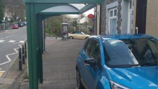 Car parked under bus stop