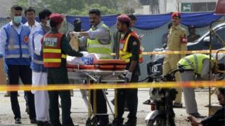 Pakistani security officials collect evidence from the scene of a suicide bomb attack on a census team in Lahore on April 5, 2017.