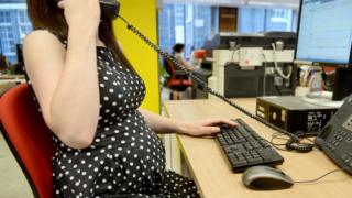 Pregnant woman at work, file pic