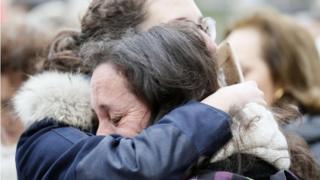 A woman cries in front of the Bataclan music hall in Paris on 13 December 2015