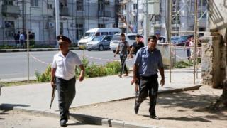 Police officers secure an area in Dushanbe where several special forces officers were shot dead on 4 September