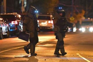 Police from the bomb squad unit walk near scene of the Melbourne siege