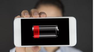 Cell phone battery nearly exhausted in the hands of a woman