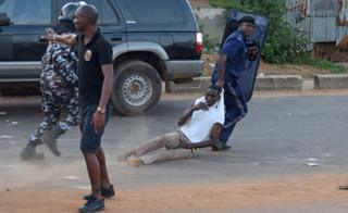 Anti riot policeman drags away a supporter of Sierra Leone People"s Party (SLPP) during a protest against the police attempting to search the offices of Julius Maada Bio, the presidential candidate for (SLPP) in Freetown, Sierra Leone March 7, 2018.
