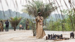 A spiritual leader of the "Eglise des Noirs" known as The Messengers of the Ancestors, performs rituals during a gathering outside Kinshasa