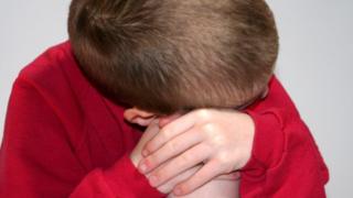 Child with head on knees