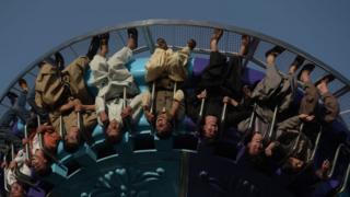 Afghan visitors ride a fairground ride at the Park Shahar or City Park, in Kabul