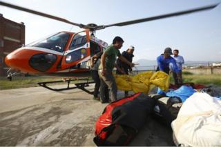 Officials carry the bodies of Indian climbers recovered from Mount Everest and airlifted to Teaching Hospital in Kathmandu on May 28, 2017.
