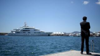 man by a yacht