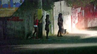 Women on a dark street in Haiti