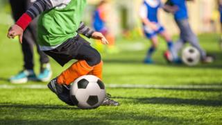 child playing football