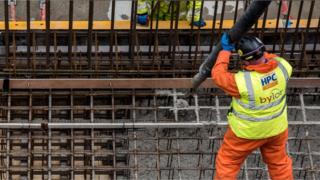 Worker pouring concrete at Hinkley C