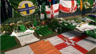 Republic of Ireland and Northern Ireland jerseys and flags mark the stop where Darren Rodgers lost his life