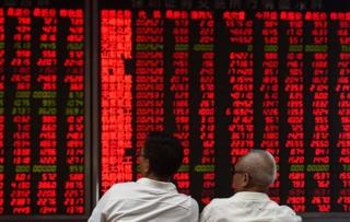 Investors monitor stock price movements at a securities company in Beijing on 15 June 2016