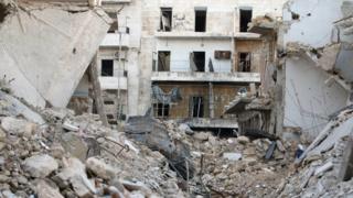 Graffiti is seen on a damaged building in Tariq al-Bab neighbourhood of Aleppo, Syria November 2, 2016