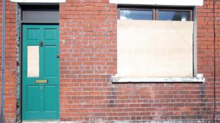 A house with damaged window and front door