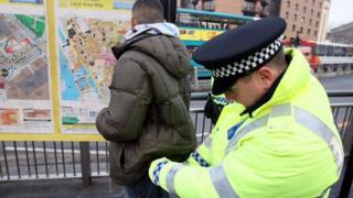 Police officer searching man