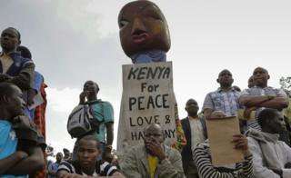 A puppeteer (C) holds a placard with message of peace during a peace prayer rally organized by different religious leaders in Nairobi, Kenya, 7 July 2017.
