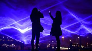 People take photos of artwork at King's Cross