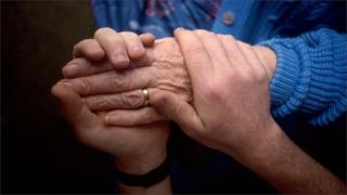Hands of carer and elderly woman